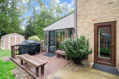 a living room with furniture and a large window with garden view