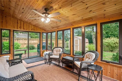 a view of a house with a yard and deck