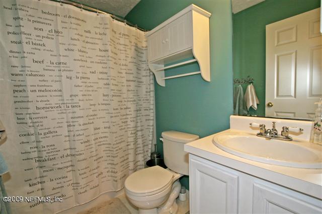 2442 Dean Road Jacksonville, FL 32216 - Photo 13 of 15 a bathroom with a sink a toilet and mirror