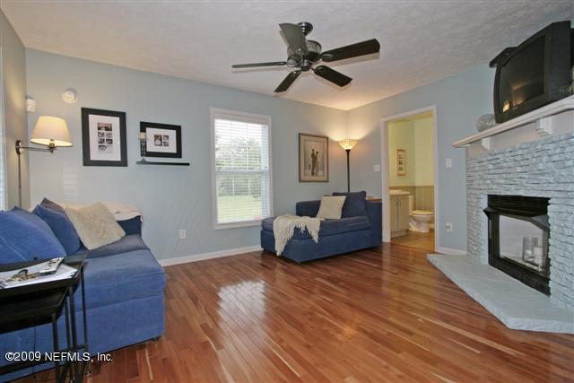 2442 Dean Road Jacksonville, FL 32216 - Photo 4 of 15 a living room with furniture a flat screen tv and a fireplace