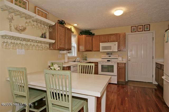 2442 Dean Road Jacksonville, FL 32216 - Photo 7 of 15 a kitchen with stainless steel appliances kitchen island granite countertop a stove a sink and a refrigerator