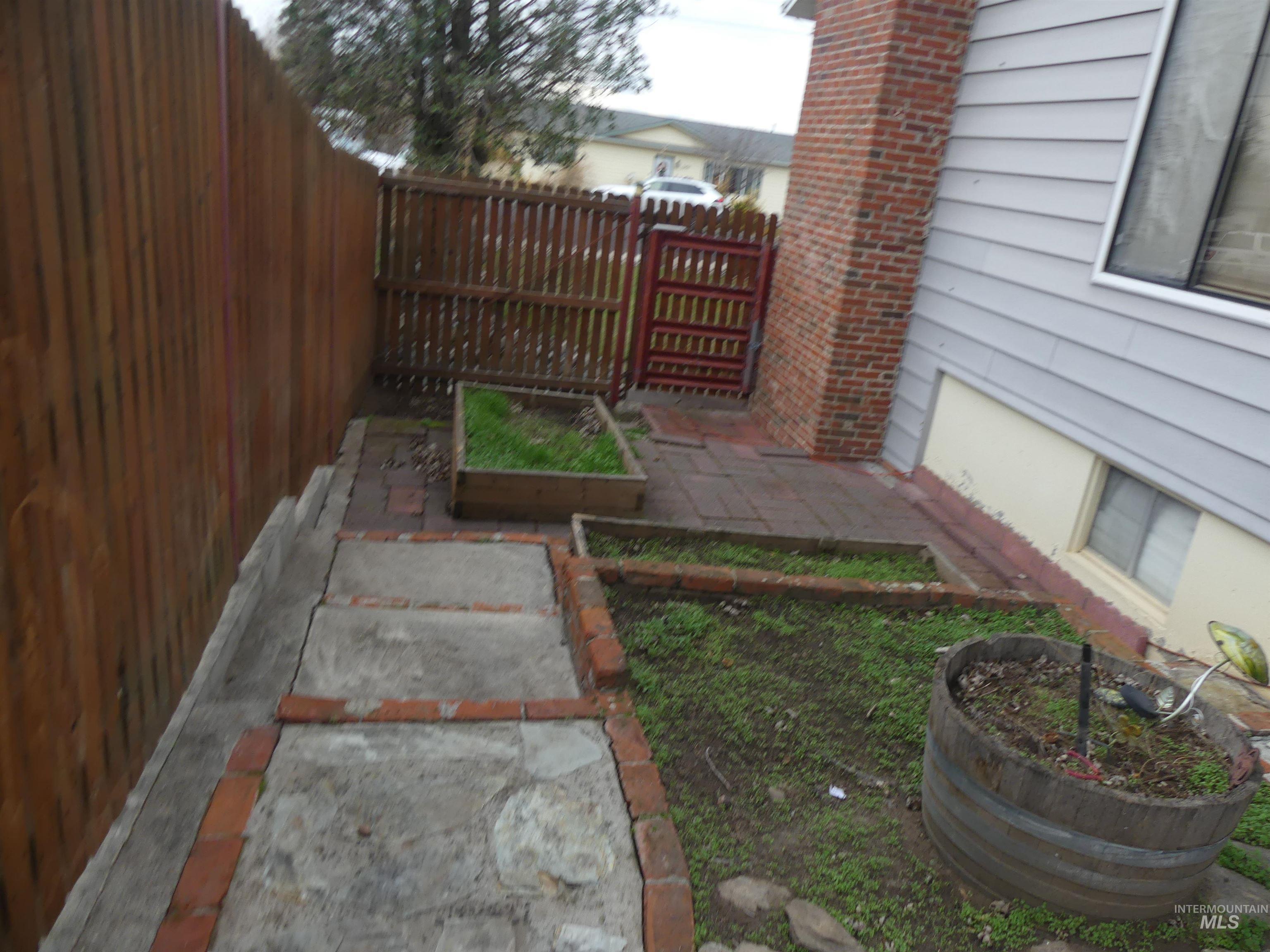 3427 18th Street Lewiston, ID 83501 - Photo 14 of 45 Fenced backyard with a patio area and a garden