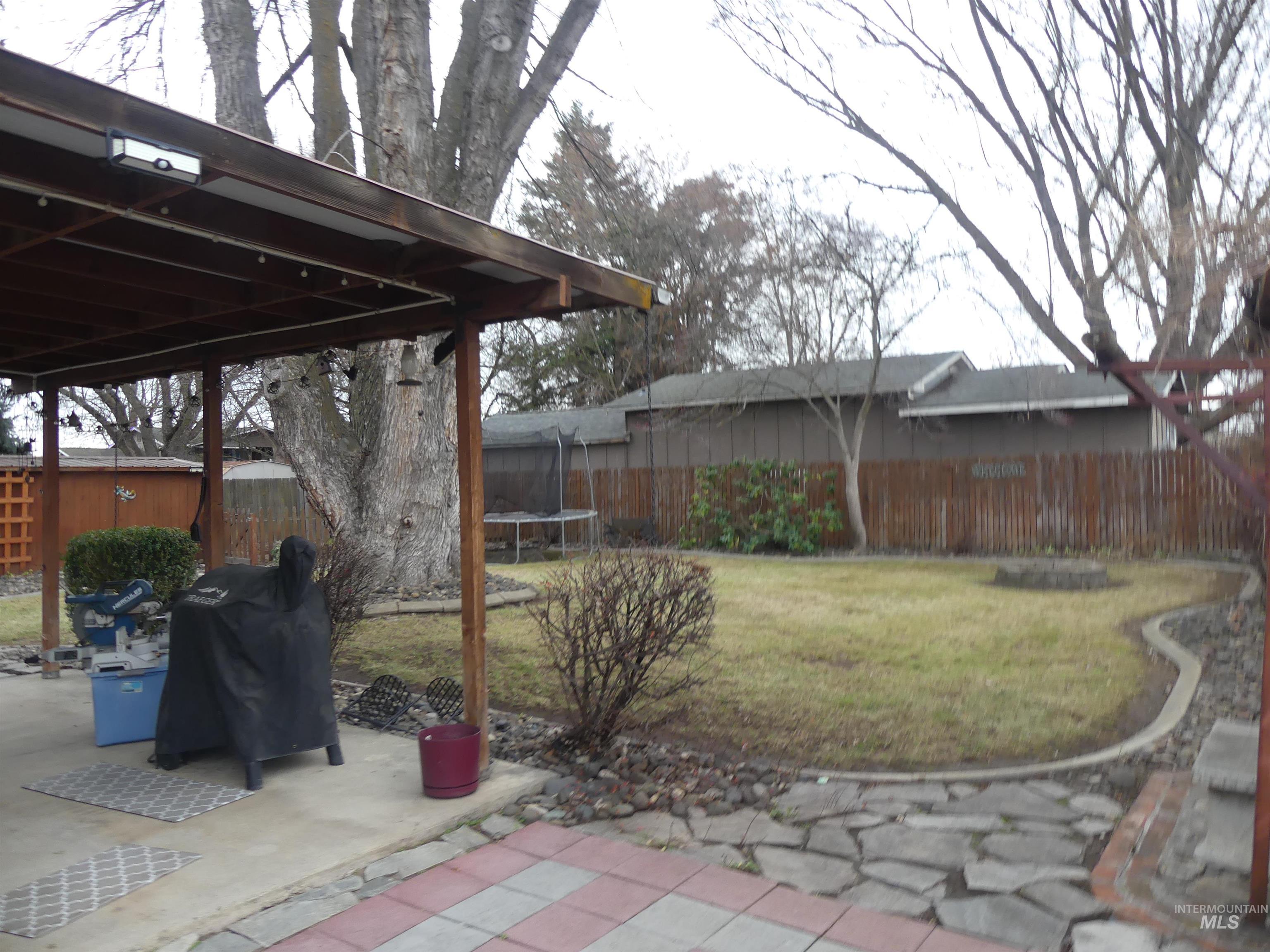 3427 18th Street Lewiston, ID 83501 - Photo 15 of 45 Fenced backyard with a trampoline, a grill, and a patio area
