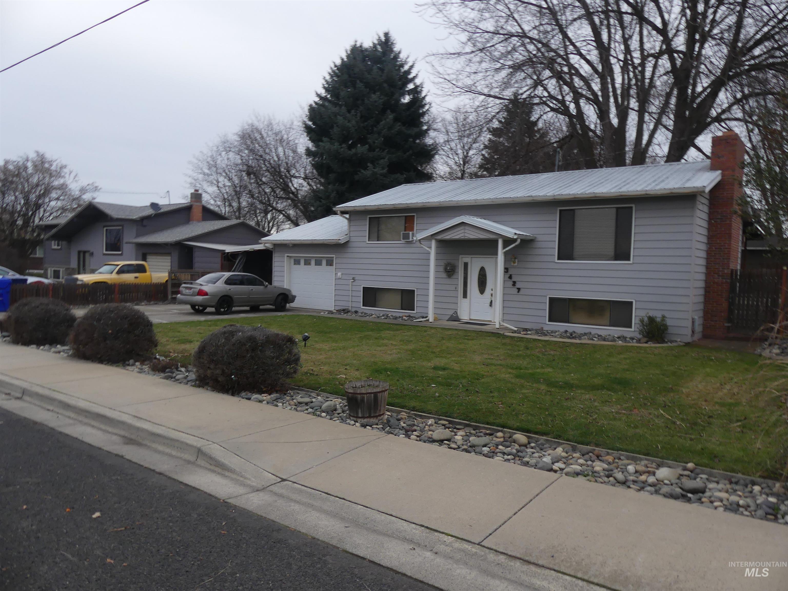 3427 18th Street Lewiston, ID 83501 - Photo 2 of 45 Raised ranch with a front yard, driveway, a garage, and a chimney