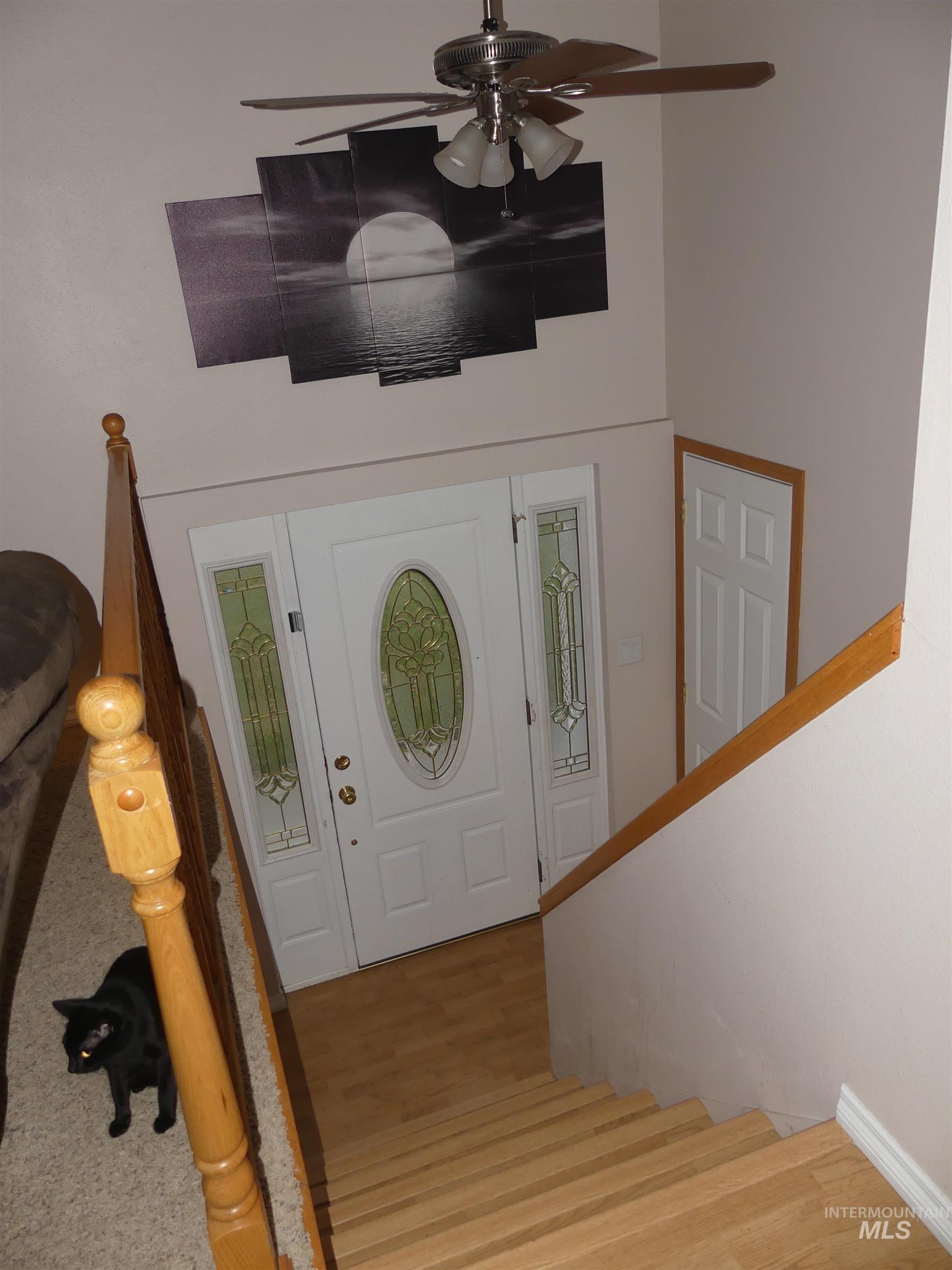 3427 18th Street Lewiston, ID 83501 - Photo 28 of 45 Foyer entrance with stairway, wood finished floors, and a ceiling fan