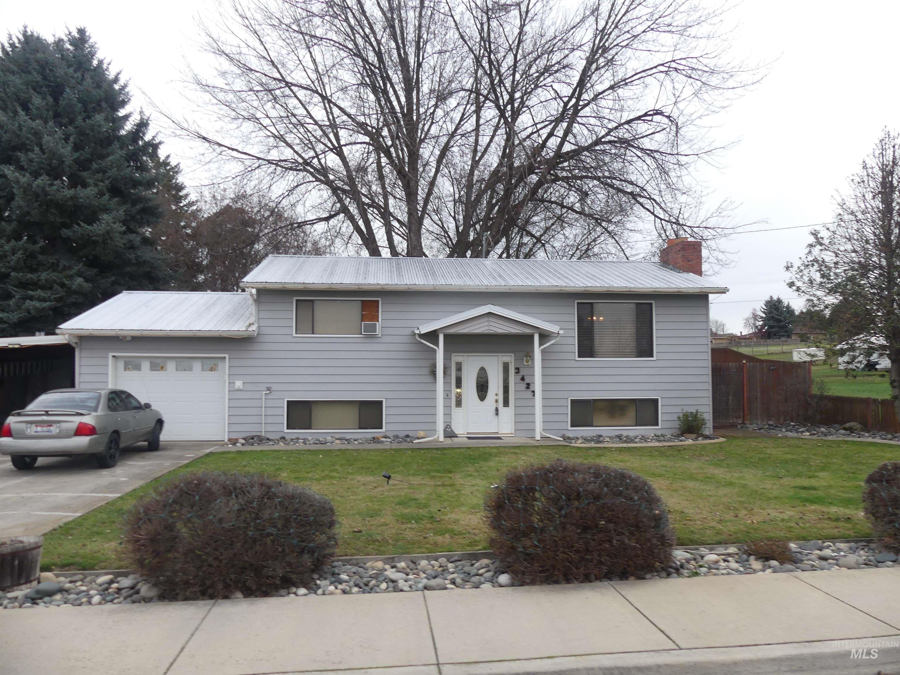 3427 18th Street Lewiston, ID 83501 - Photo 5 of 45 Raised ranch with driveway, a chimney, a garage, and a metal roof