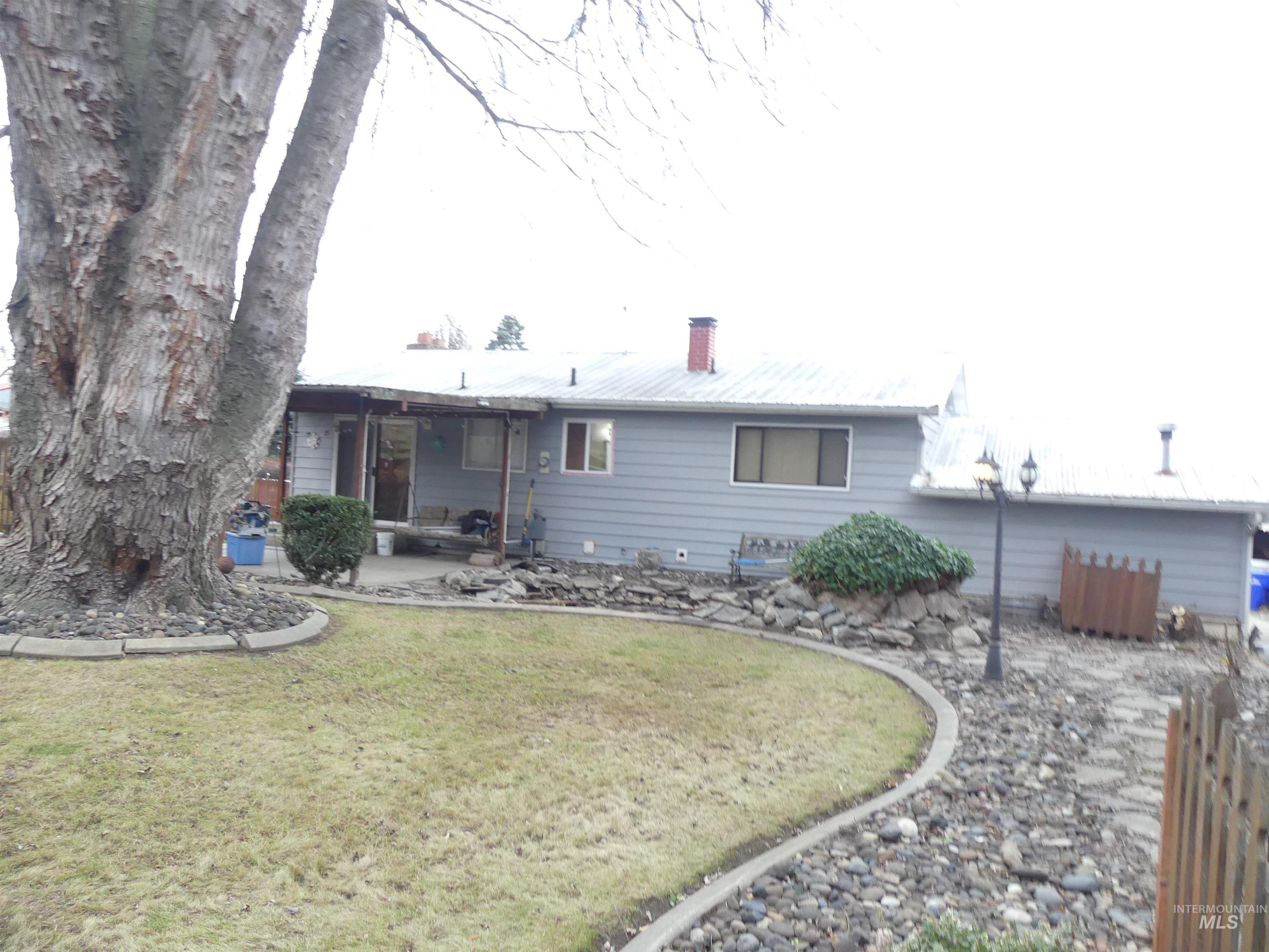 3427 18th Street Lewiston, ID 83501 - Photo 9 of 45 Rear view of house with a chimney and a patio area