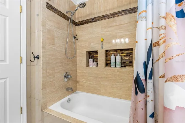 a bathroom with a bathtub and shower