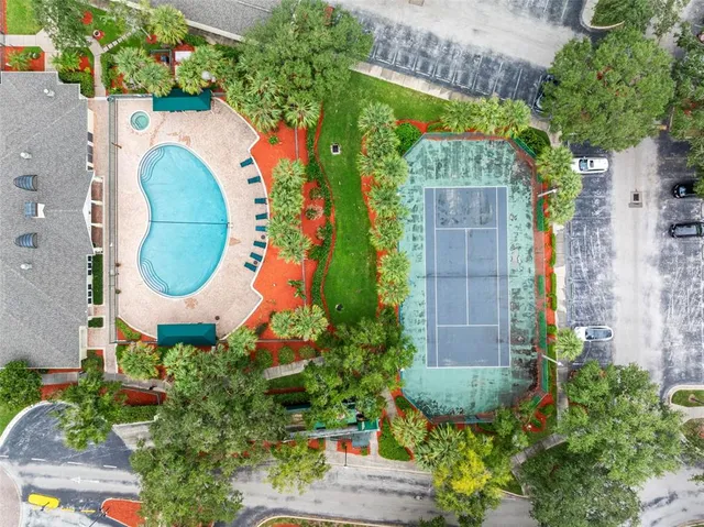 an aerial view of a house with a swimming pool and outdoor seating