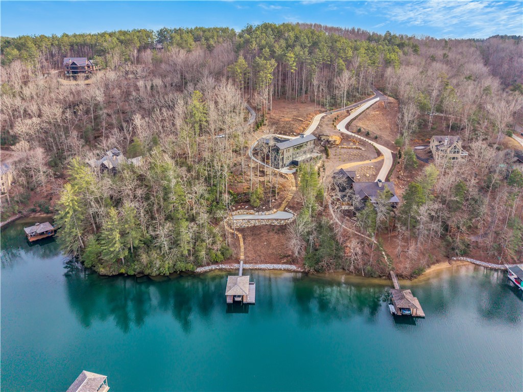 127 Crosswind Court Sunset, SC 29685 - Photo 43 of 49 An aerial perspective reveals a serene lakeside property nestled amidst lush woodlands with private docks.