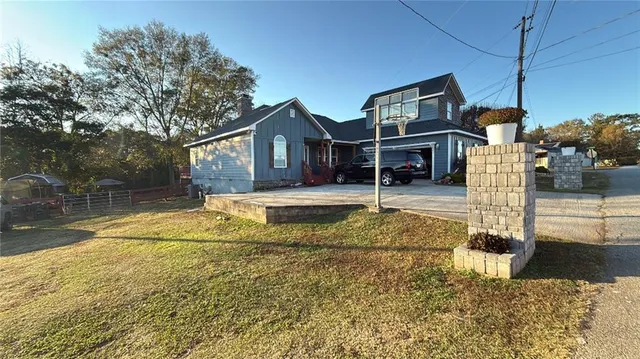a house view with swimming pool in front of it