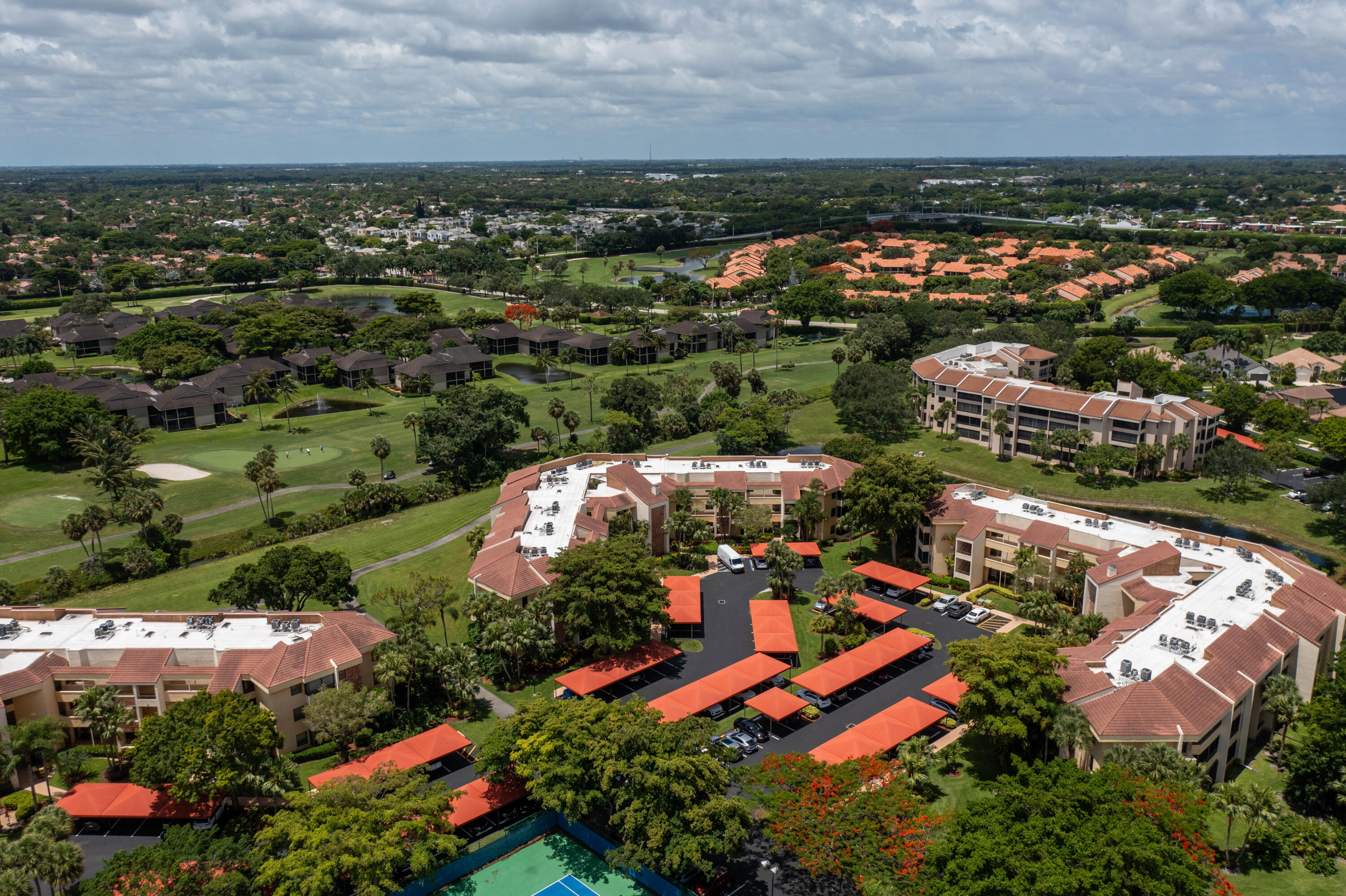 7520 La Paz Boulevard, Unit 104 Boca Raton, FL 33433 - Photo 7 of 56 an aerial view of residential houses with outdoor space and trees