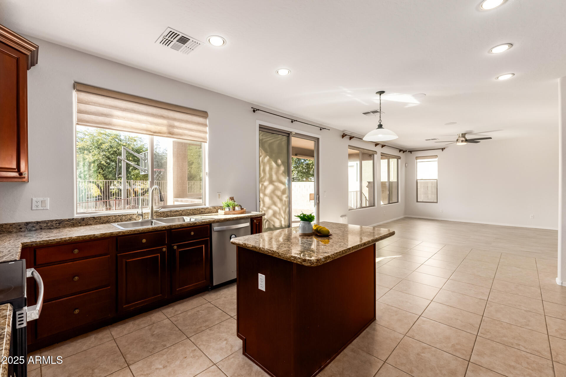 35822 North 33rd Lane Phoenix, AZ 85086 - Photo 13 of 54 a large kitchen with kitchen island granite countertop a sink and a white cabinets
