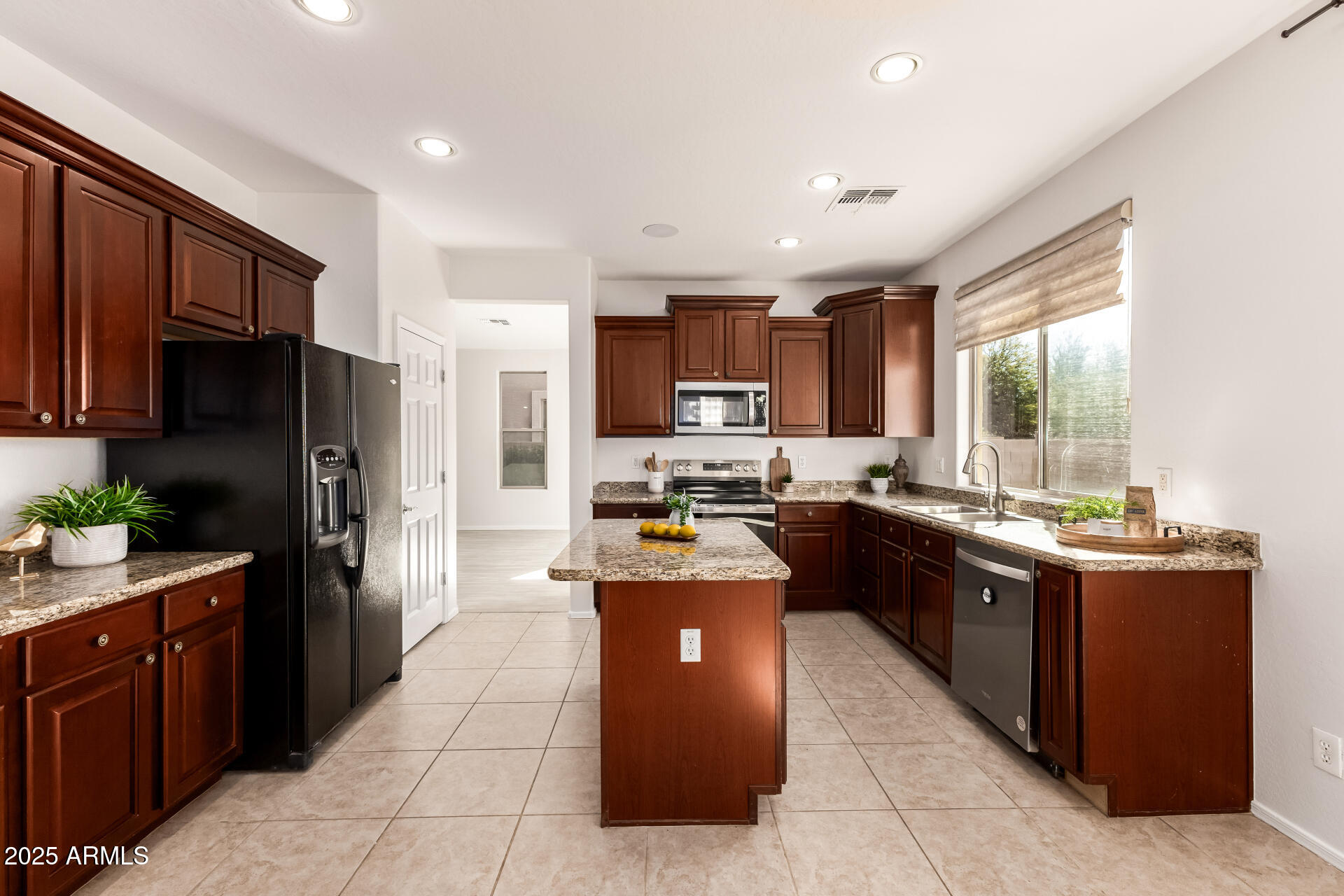 35822 North 33rd Lane Phoenix, AZ 85086 - Photo 14 of 54 a large kitchen with stainless steel appliances granite countertop a stove refrigerator and a sink
