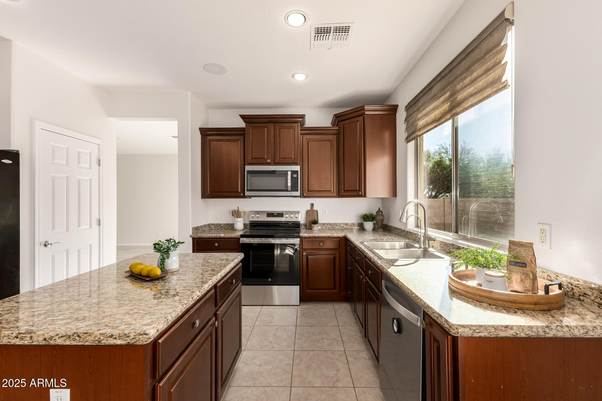 35822 North 33rd Lane Phoenix, AZ 85086 - Photo 16 of 54 a kitchen with stainless steel appliances granite countertop sink stove top oven and cabinets