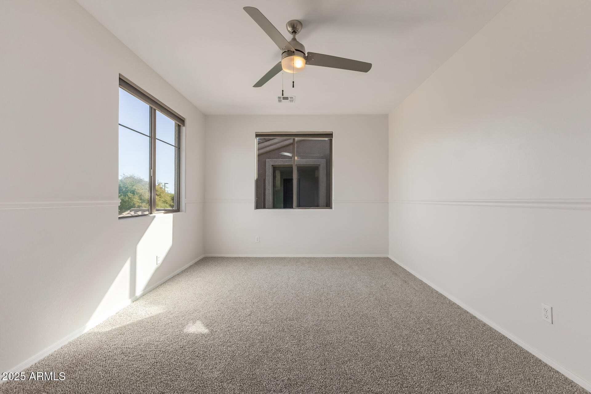 35822 North 33rd Lane Phoenix, AZ 85086 - Photo 39 of 54 an empty room with a window and a ceiling fan