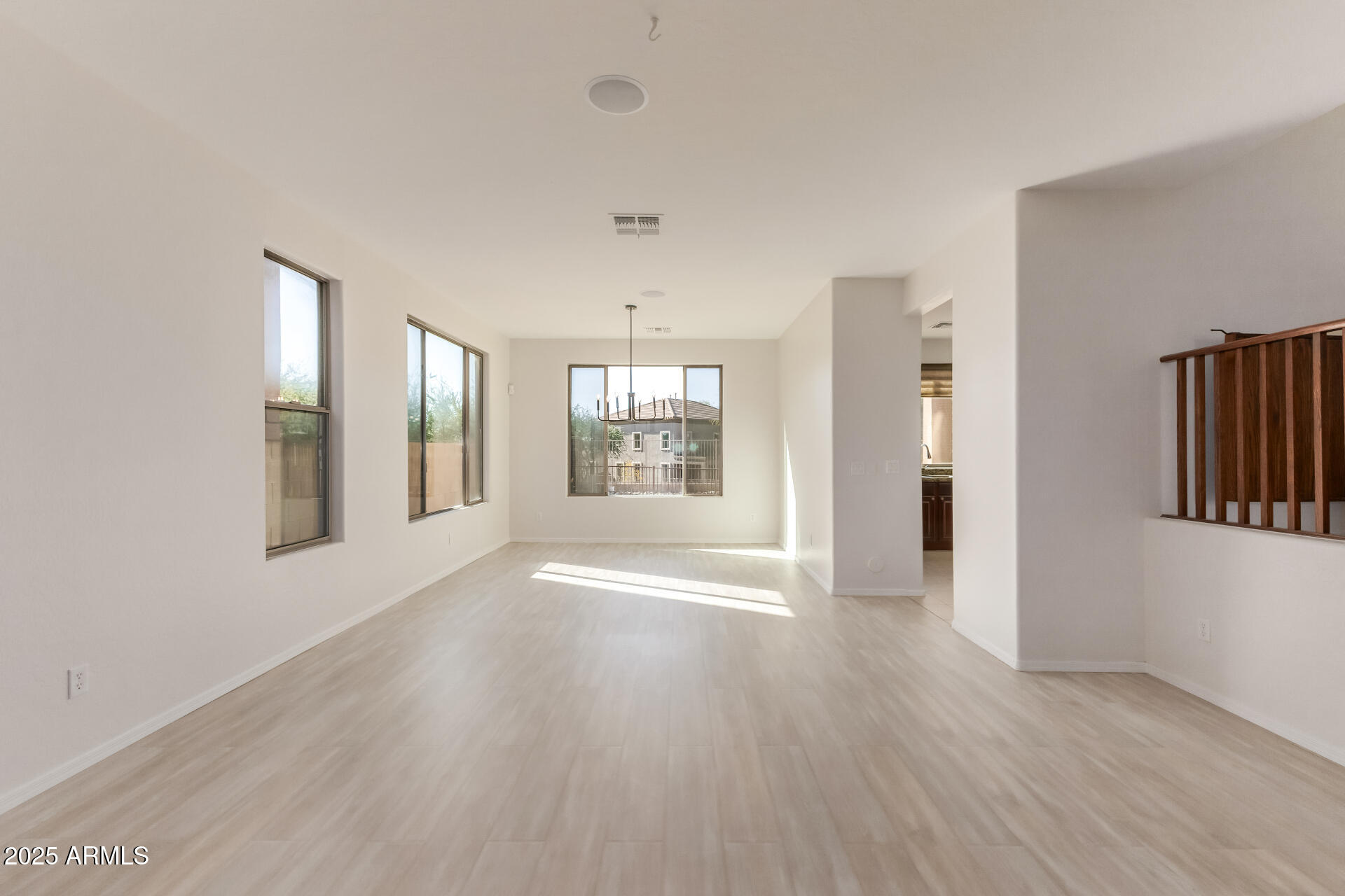 35822 North 33rd Lane Phoenix, AZ 85086 - Photo 6 of 54 a view of an empty room with wooden floor and a window