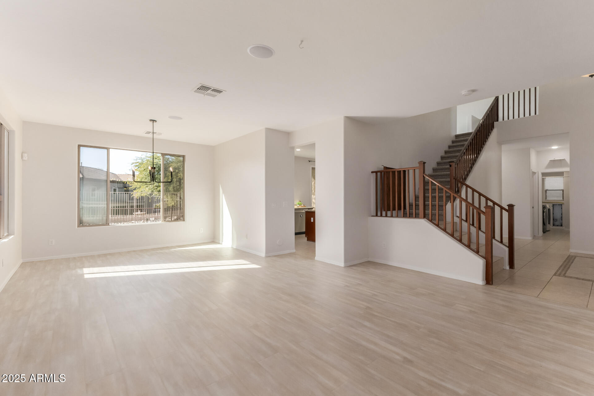 35822 North 33rd Lane Phoenix, AZ 85086 - Photo 7 of 54 a view of an empty room with wooden floor and a window
