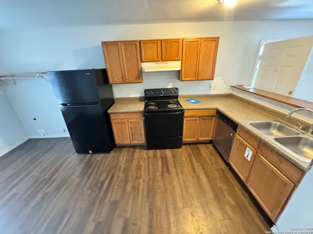 a kitchen with wooden cabinets and a sink