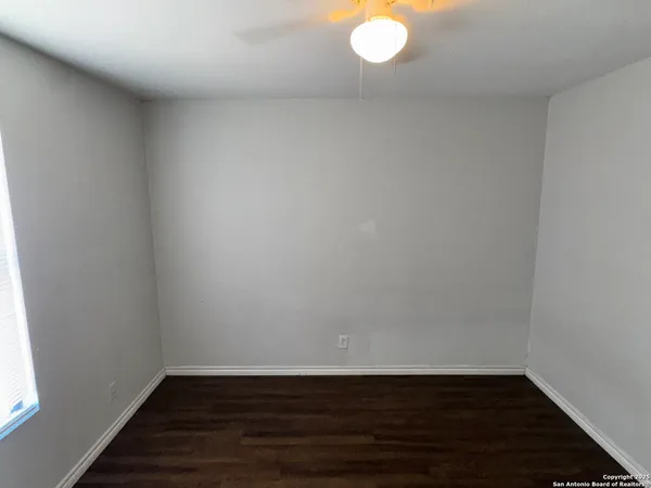 a view of an empty room and wooden floor