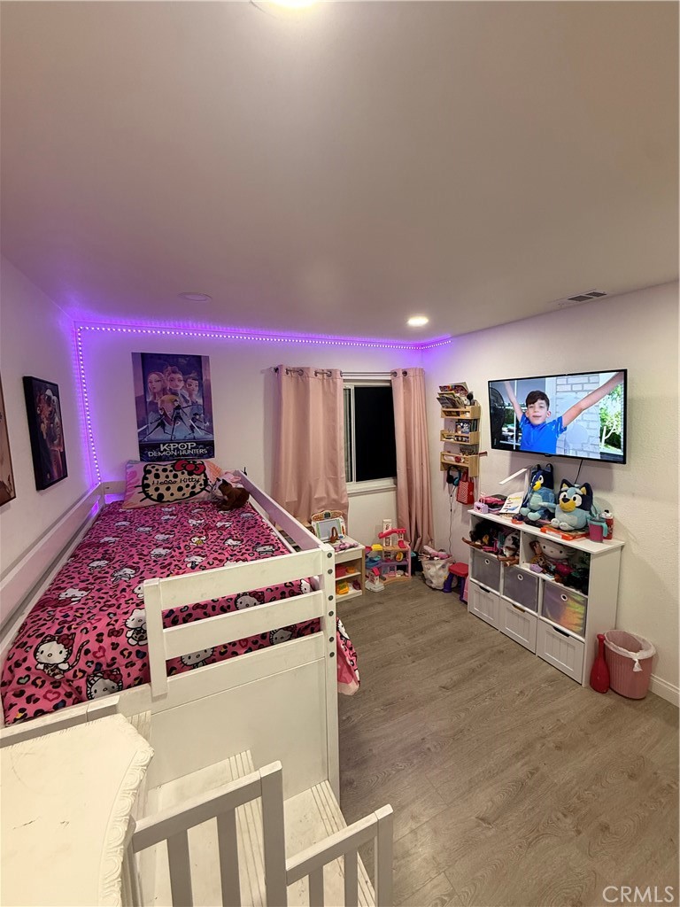 2606 North Palm Avenue Rialto, CA 92377 - Photo 11 of 29 a living room with furniture a flat screen tv and a wall painting