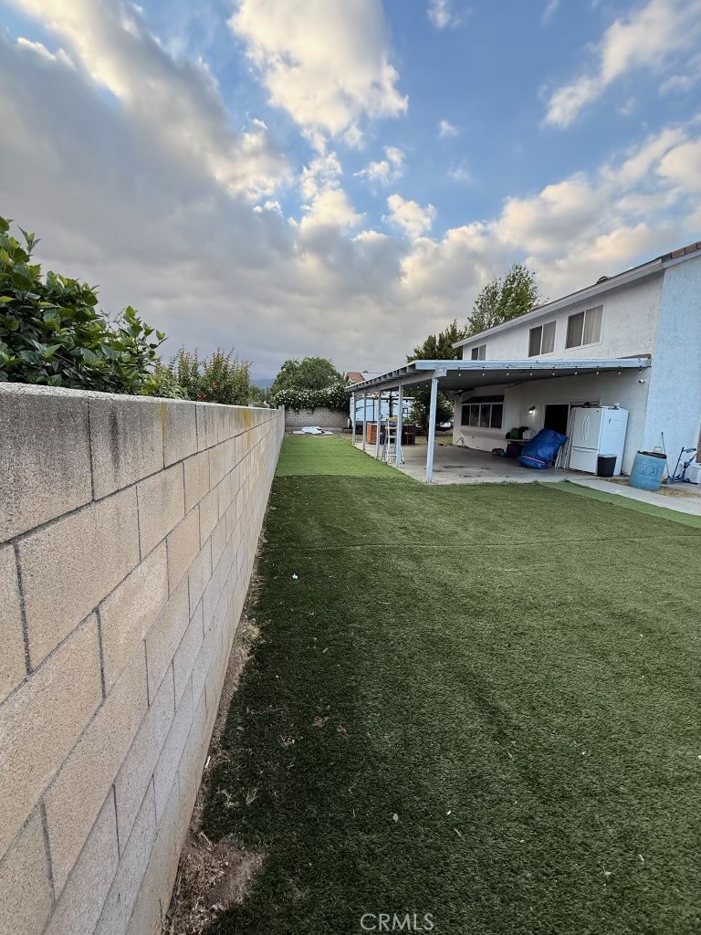 2606 North Palm Avenue Rialto, CA 92377 - Photo 17 of 29 a view of a house with a yard and sitting area