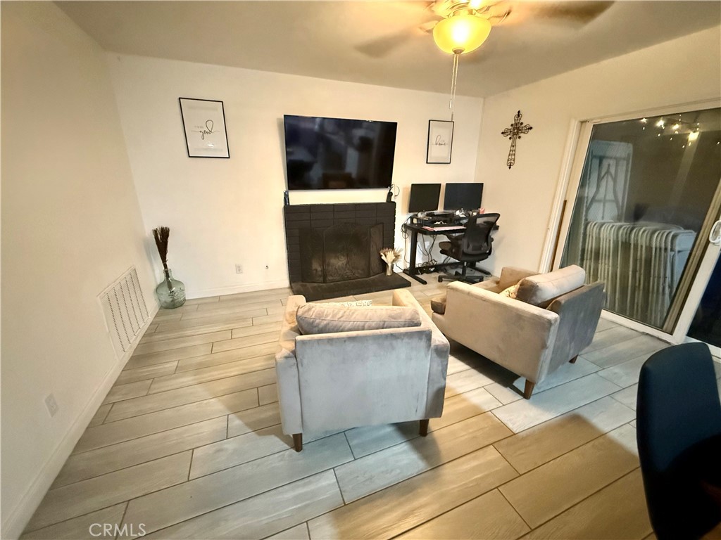 2606 North Palm Avenue Rialto, CA 92377 - Photo 25 of 29 a living room with furniture and a flat screen tv