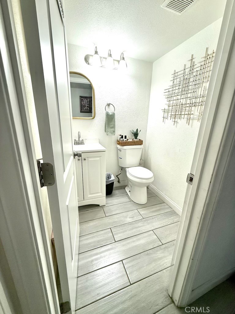 2606 North Palm Avenue Rialto, CA 92377 - Photo 27 of 29 a bathroom with a sink a toilet and a mirror