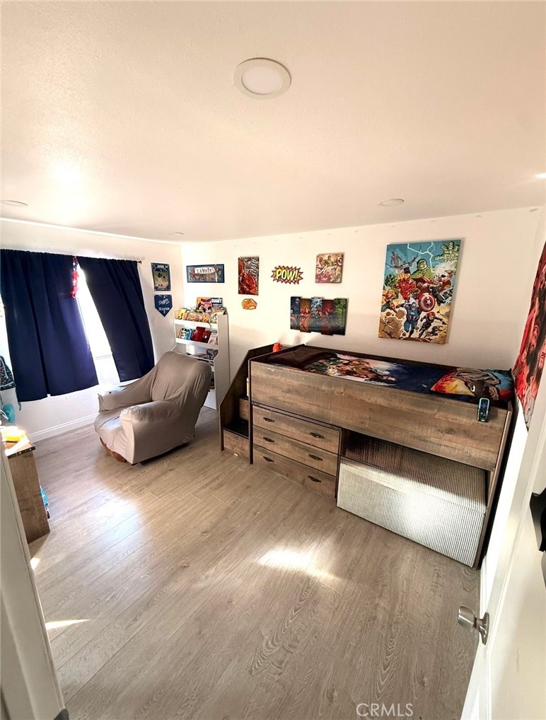 2606 North Palm Avenue Rialto, CA 92377 - Photo 7 of 29 a bedroom with furniture and a book shelf