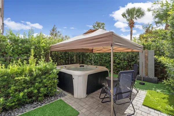 a view of backyard with plants and outdoor seating