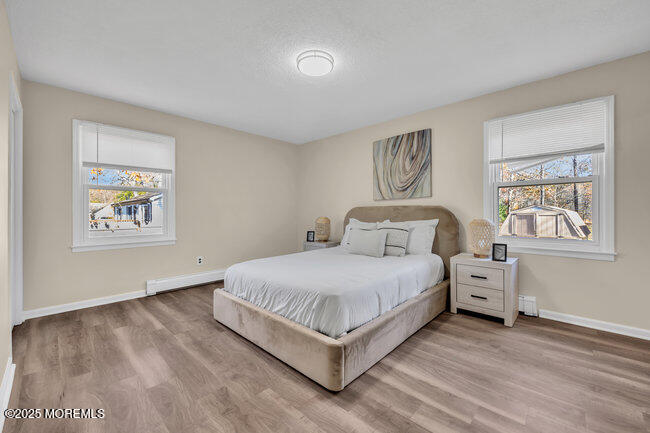 153 Cedar Swamp Road Jackson, NJ 08527 - Photo 13 of 21 a bedroom with a bed and a painting on the wall