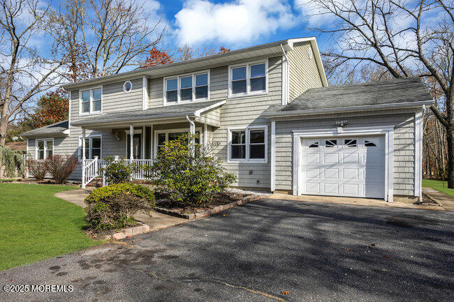 153 Cedar Swamp Road Jackson, NJ 08527 - Photo 3 of 21 a front view of a house with a garden