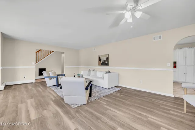 a living room with furniture and a chandelier