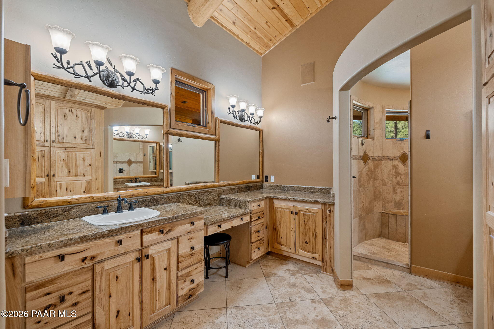 5140 East Charcoal Kiln Road Prescott, AZ 86303 - Photo 52 of 140 a spacious bathroom with a granite countertop sink a mirror and a shower