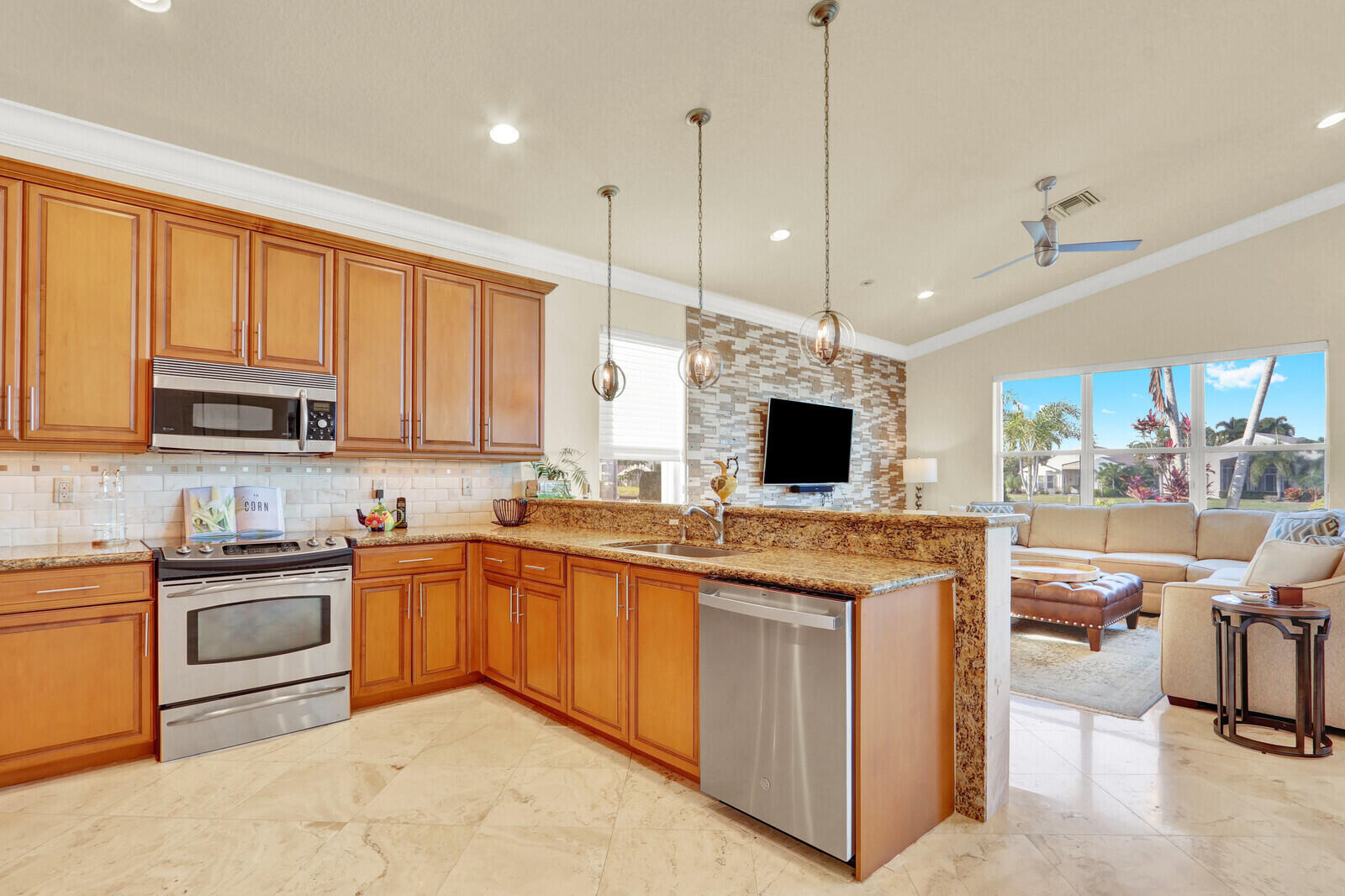7349 Carmela Way Delray Beach, FL 33446 - Photo 20 of 82 a kitchen with stainless steel appliances granite countertop wooden cabinets a sink a stove a dining table and chairs
