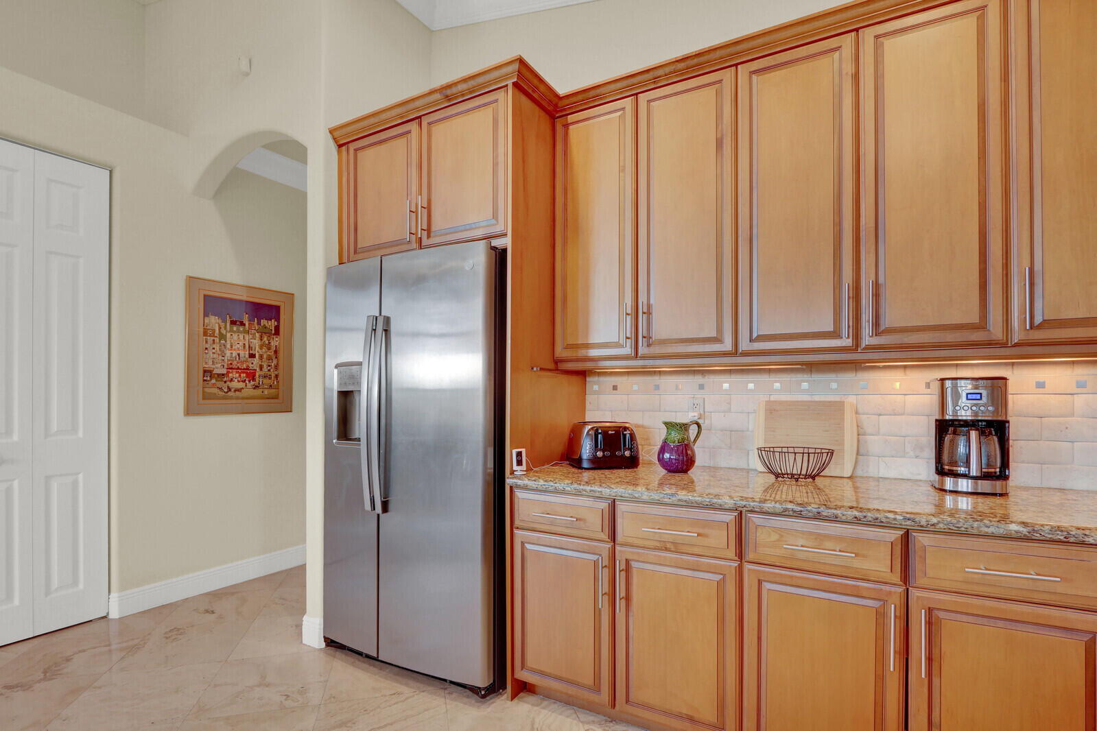7349 Carmela Way Delray Beach, FL 33446 - Photo 22 of 82 a kitchen with stainless steel appliances granite countertop a refrigerator and cabinets