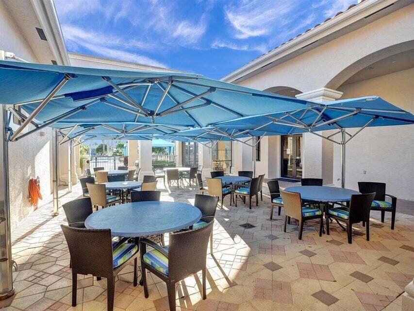 7349 Carmela Way Delray Beach, FL 33446 - Photo 67 of 82 a view of a dining table and chairs in the patio