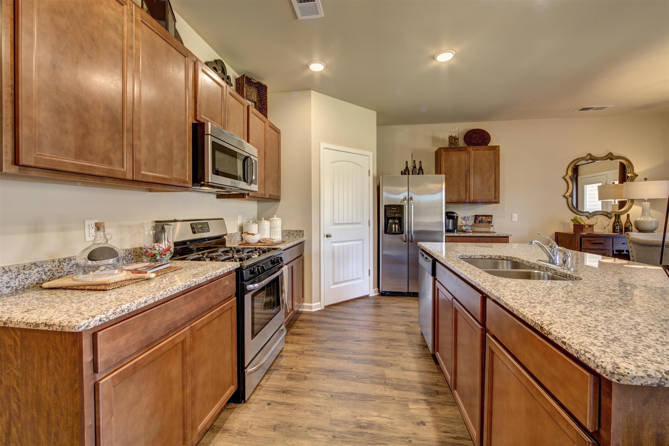 743 Prominence Road, Unit 97 Columbia, TN 38401 - Photo 11 of 23 a large kitchen with stainless steel appliances granite countertop a stove top oven a sink and dishwasher