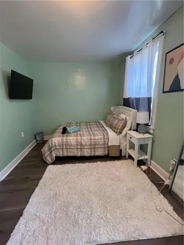 a bedroom with a bed and a television
