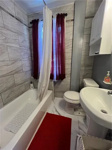 a bathroom with a sink a toilet and bathtub