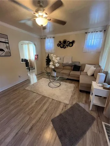 a living room with furniture and a lamp