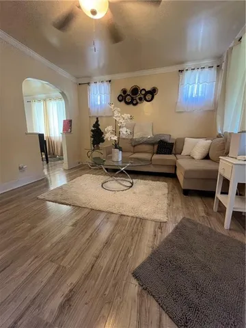 a living room with furniture and wooden floor