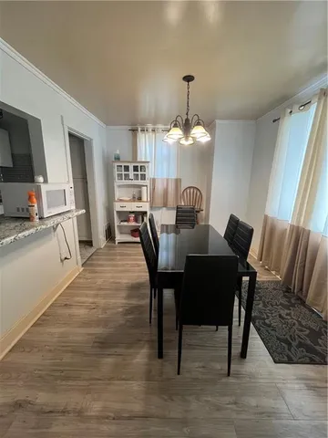 a view of a dining room with furniture and wooden floor