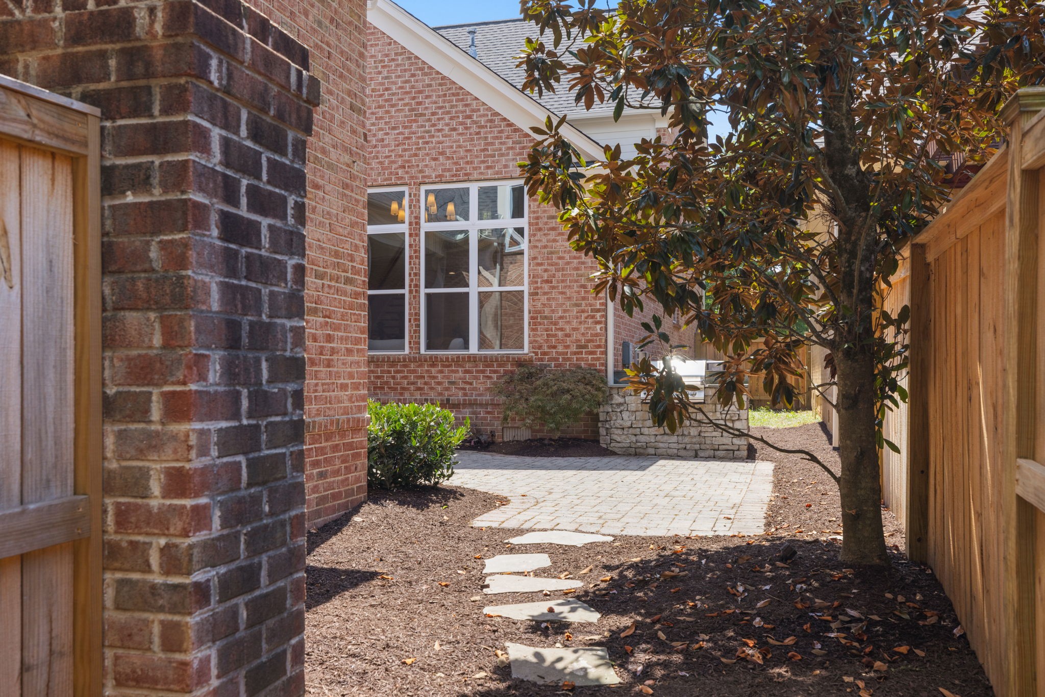 128 Addison Avenue Franklin, TN 37064 - Photo 74 of 81 a view of a brick house with a yard and large trees