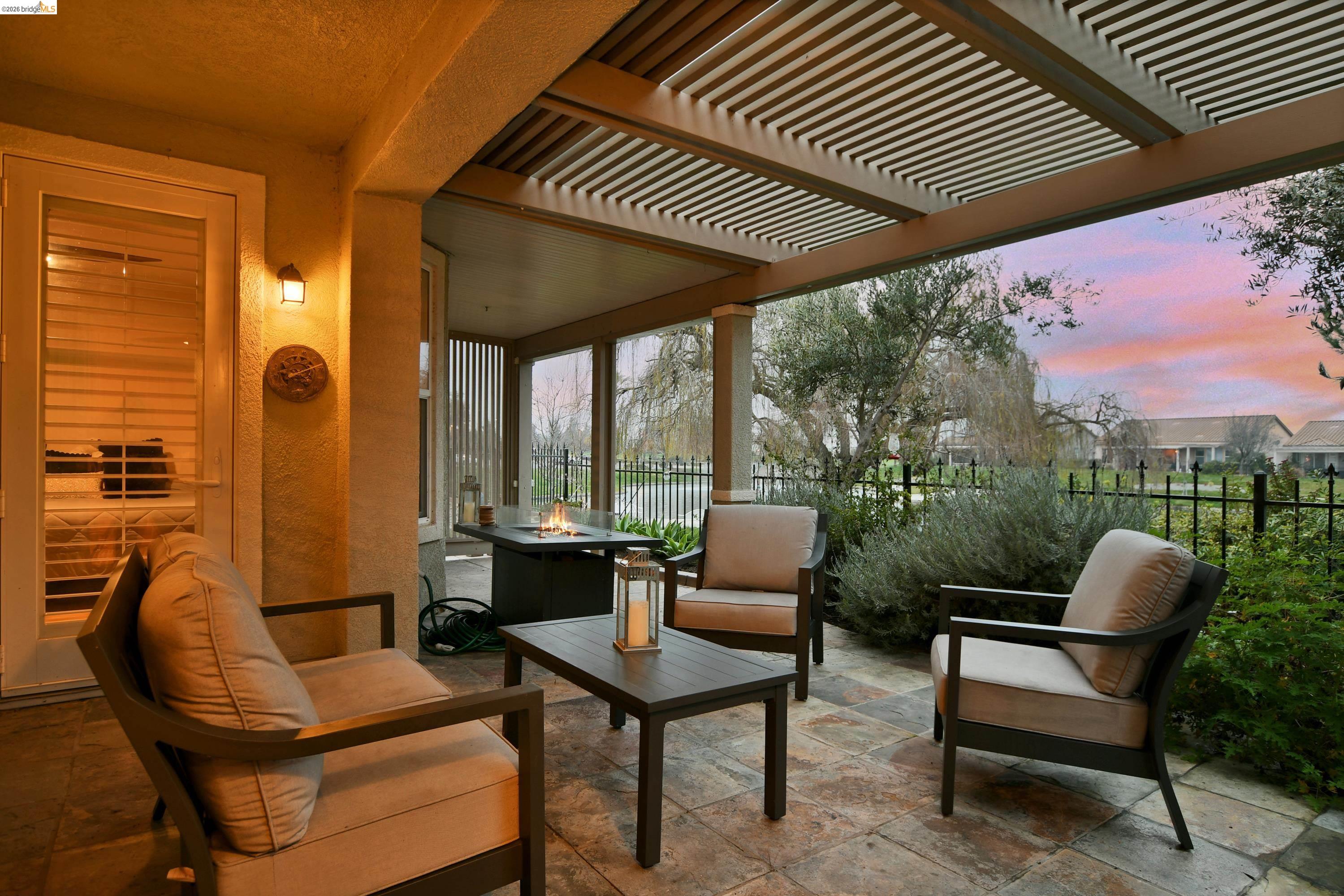 342 Desert Forest Court Rio Vista, CA 94571 - Photo 8 of 40 Patio terrace at dusk featuring a patio area, a pergola, and an outdoor living space with a fire pit