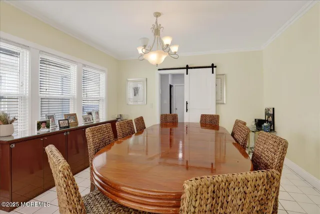 a view of a dining room with furniture and a chandelier