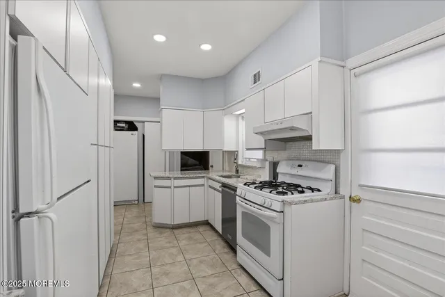 a kitchen that has a table chairs and wooden floor