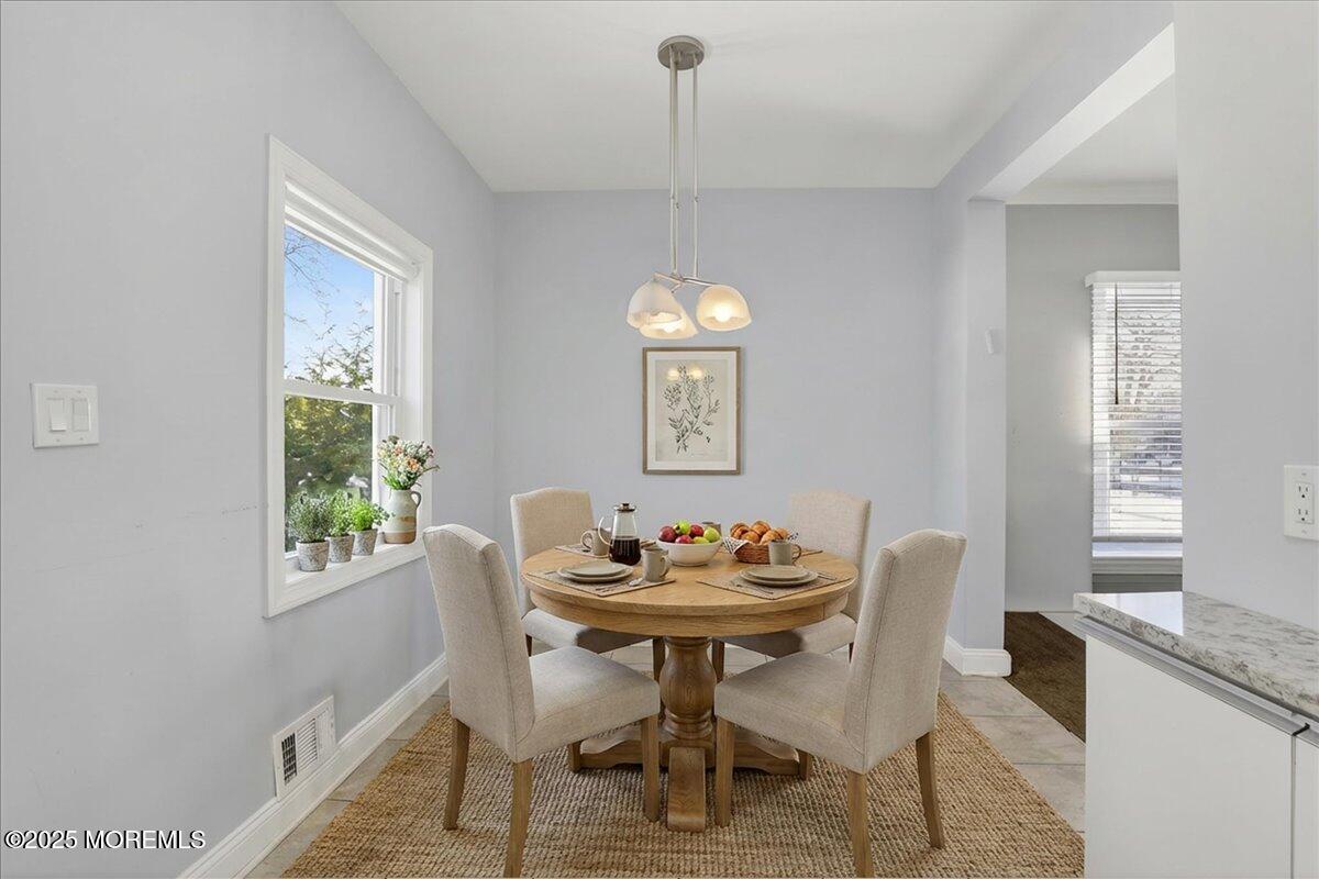 57 Hathaway Avenue Deal, NJ 07723 - Photo 23 of 37 a dining room with furniture a chandelier and wooden floor