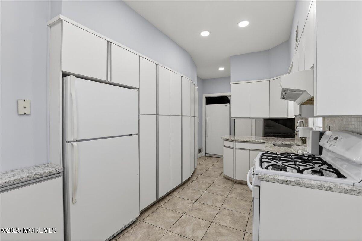 57 Hathaway Avenue Deal, NJ 07723 - Photo 24 of 37 a white refrigerator freezer and a stove in a kitchen