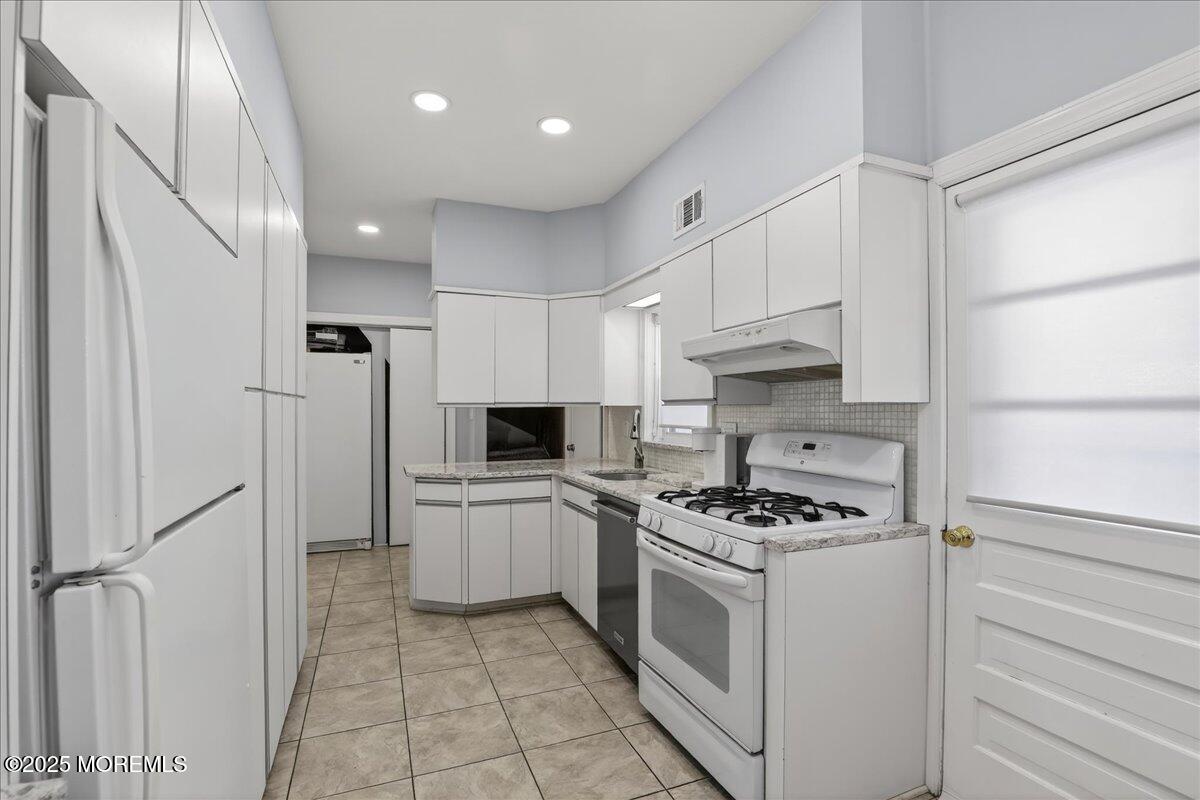 57 Hathaway Avenue Deal, NJ 07723 - Photo 25 of 37 a kitchen with cabinets and steel appliances